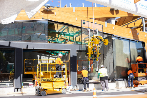 Glass window being lifted up and fitted into The Pā 