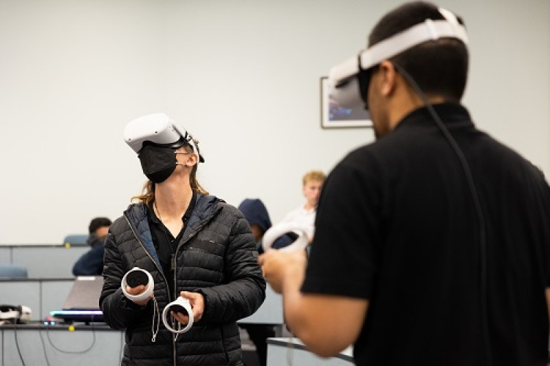 Two people using virtual reality headsets.