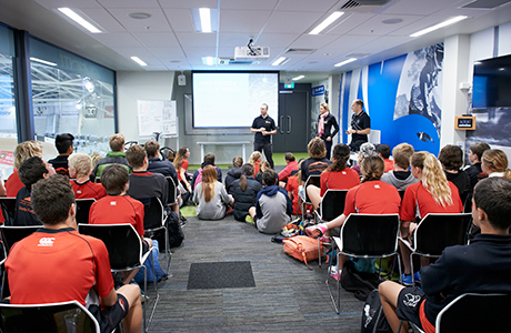 Group of people watching a presentation.